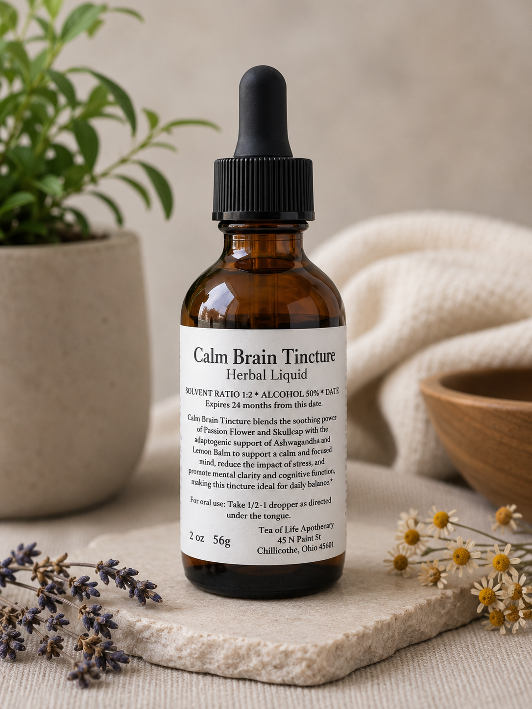 Amber glass Calm Brain herbal tincture bottle displayed with lavender, chamomile flowers, and soft natural decor in a calming wellness-inspired apothecary setting.