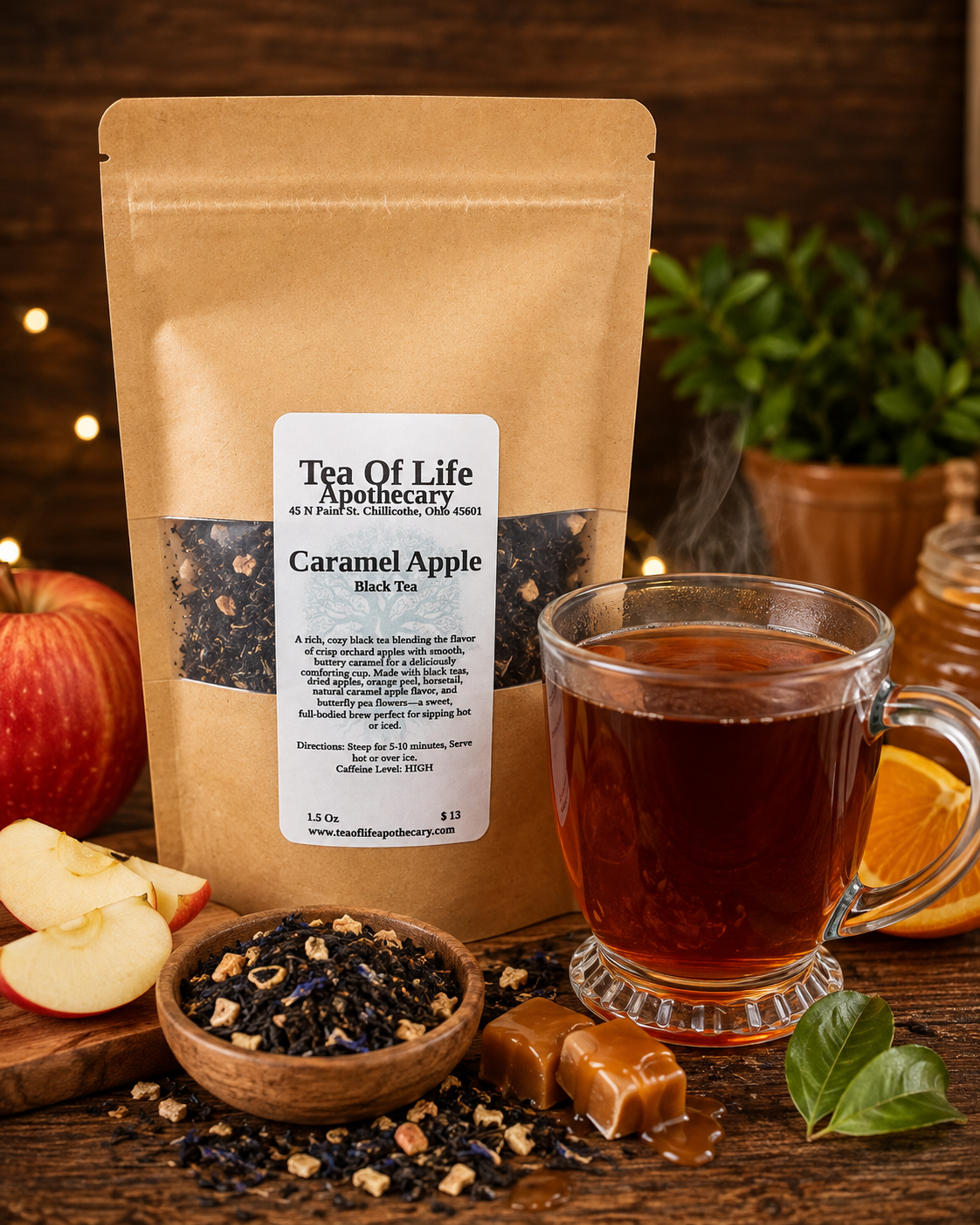 Caramel Apple Black Tea by Tea of Life Apothecary, a loose leaf black tea with dried apples, orange peel, horsetail and butterfly pea flowers, featuring rich caramel apple flavor and pictured with a warm cup of tea and fresh apples.