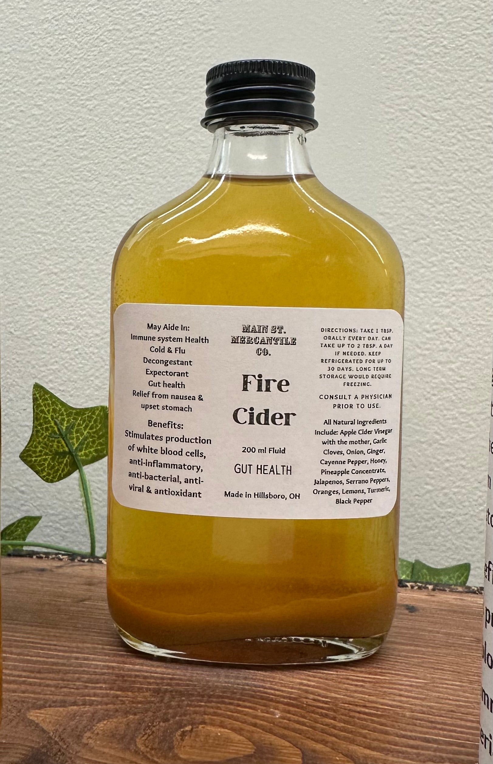 Fire cider herbal tonic with apple cider vinegar, garlic, cayenne, citrus and turmeric for immune support, digestion and cold and flu season