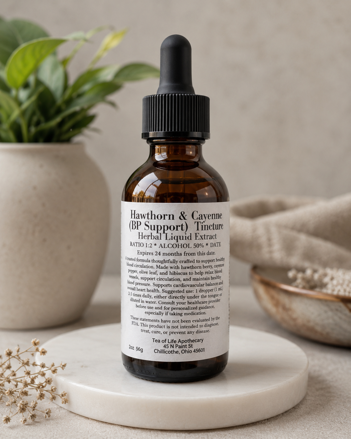 Amber glass Hawthorn and Cayenne herbal tincture bottle for blood pressure support displayed on a neutral wellness-inspired background with soft natural lighting and botanical decor.