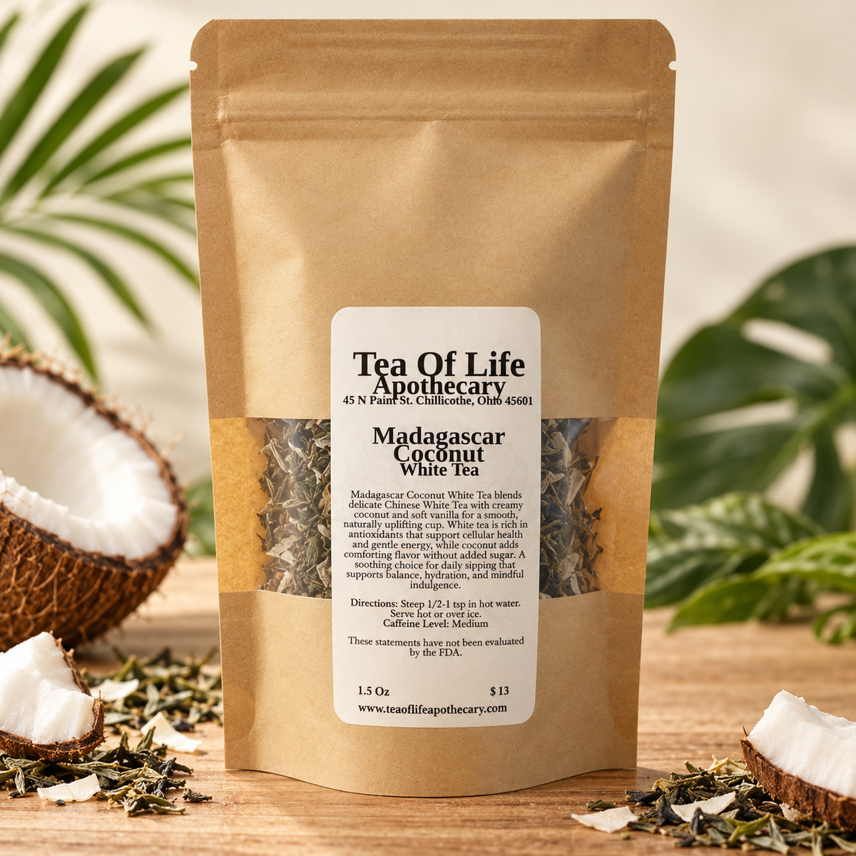 Madagascar Coconut White Tea by Tea of Life Apothecary in a kraft tea pouch, displayed with coconut pieces, loose white tea leaves, and tropical greenery.