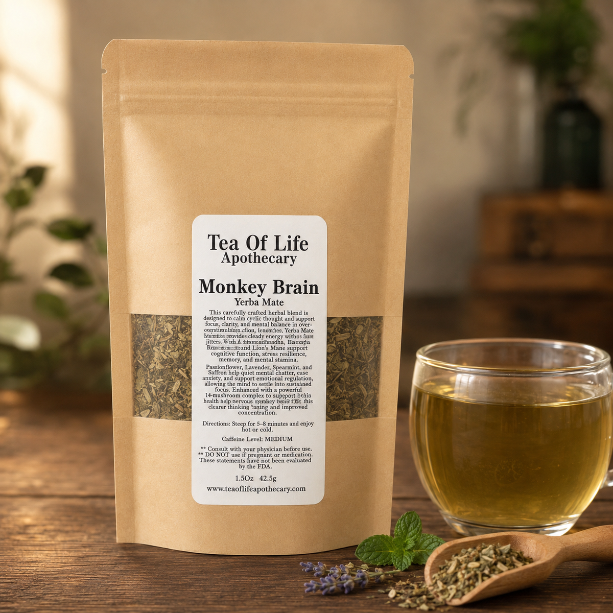 Tea of Life Apothecary Monkey Brain Yerba Mate blend displayed with loose herbs, mint, lavender, and a clear cup of golden brewed tea.