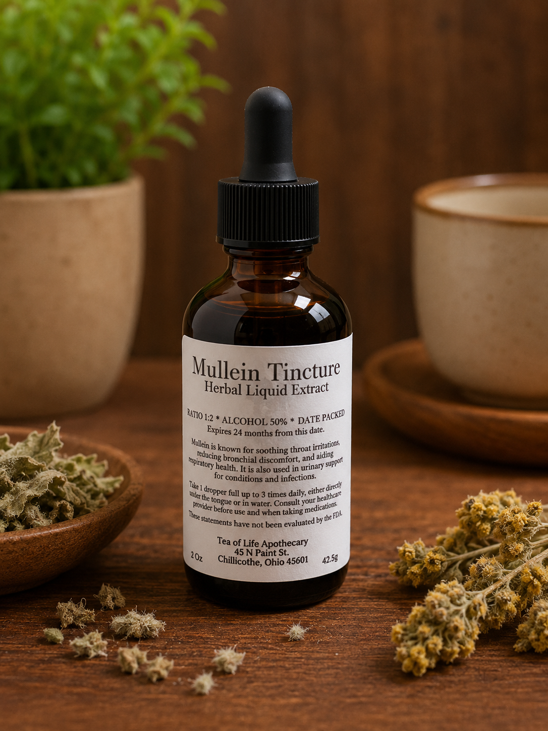Tea of Life Apothecary Mullein Herbal Liquid Extract tincture bottle displayed on a rustic wooden table with dried mullein herbs in a warm apothecary-style setting.