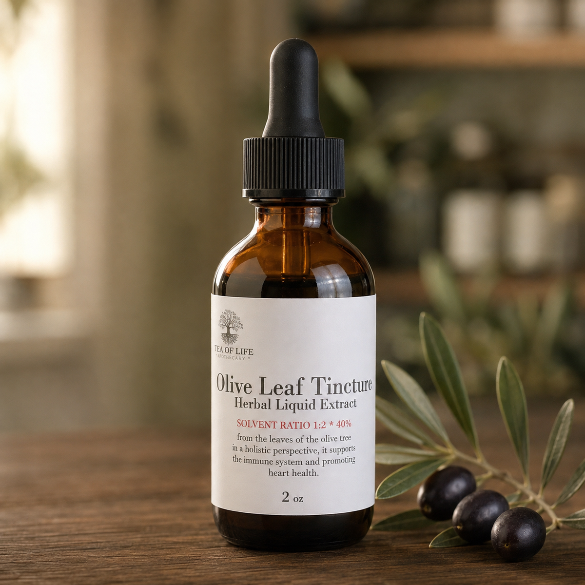 Tea of Life Apothecary Olive Leaf Tincture in an amber glass dropper bottle displayed with fresh olive leaves and dark olives.