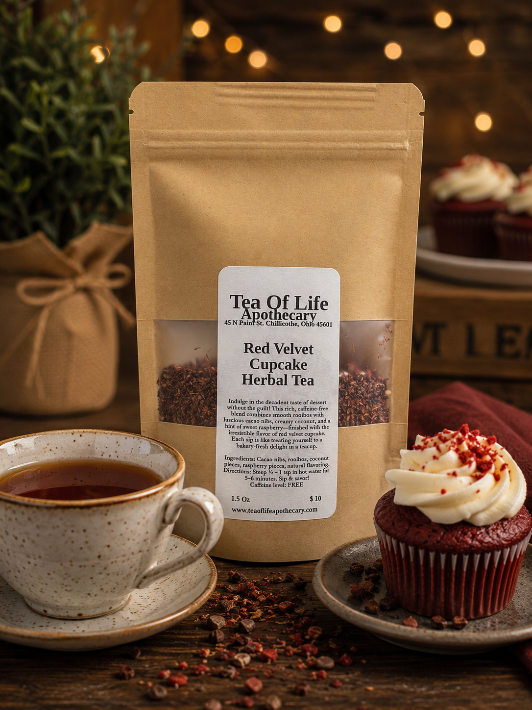 Tea of Life Apothecary Red Velvet Cupcake Herbal Tea, a caffeine-free rooibos tea blend with cacao nibs, coconut, and raspberry, displayed with a steaming teacup and a red velvet cupcake in a warm bakery-inspired setting.