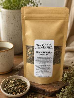 Silent Warrior Herbal Tea by Tea of Life Apothecary displayed in a rustic apothecary setting with a ceramic tea cup, loose herbal blend, and warm natural lighting, highlighting an immune and wellness support herbal tea blend.