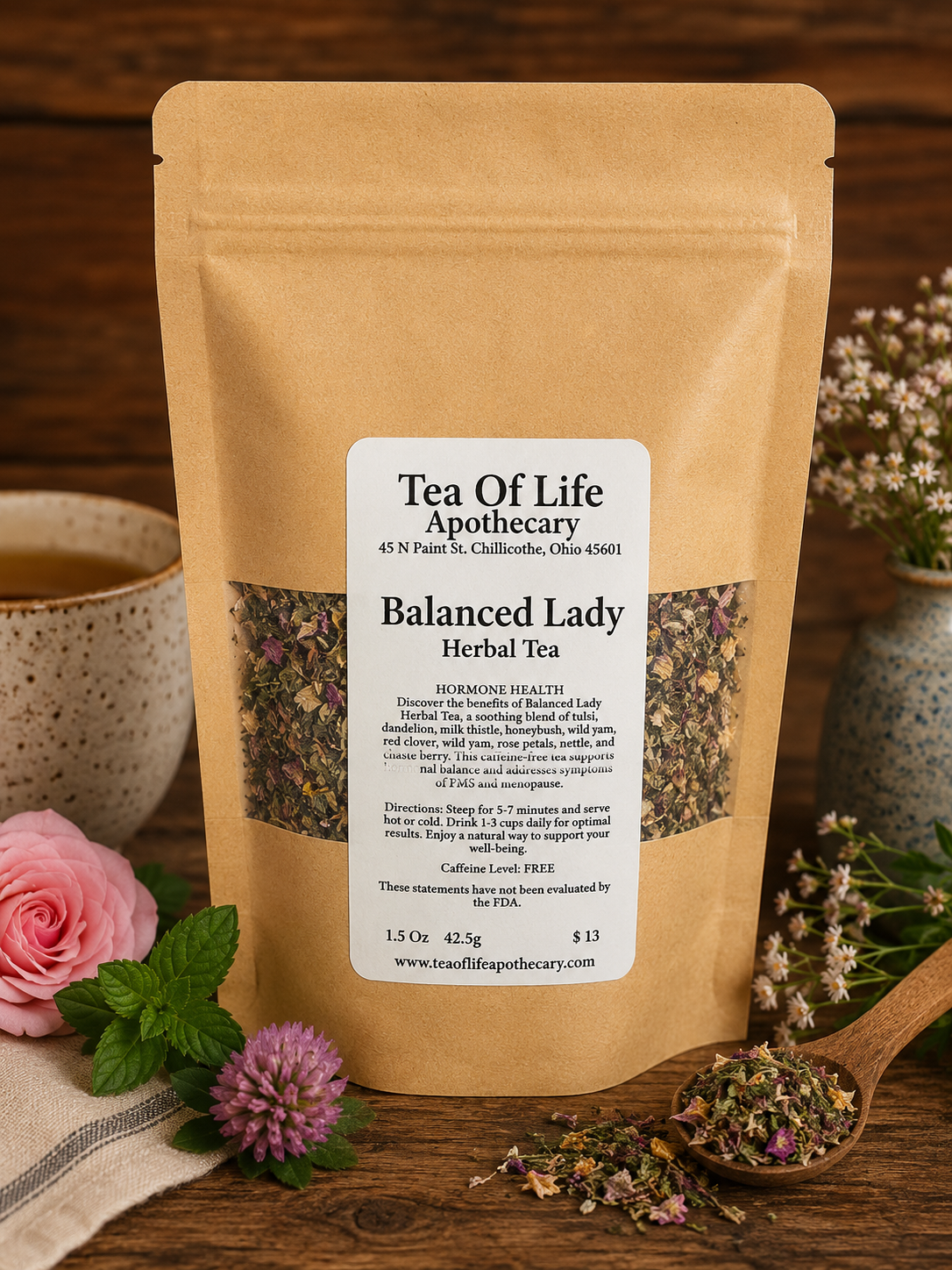 Balanced Lady Herbal Tea by Tea of Life Apothecary displayed with feminine herbs, rose petals, and a warm cup of tea in a rustic wellness-inspired setting for hormone support.