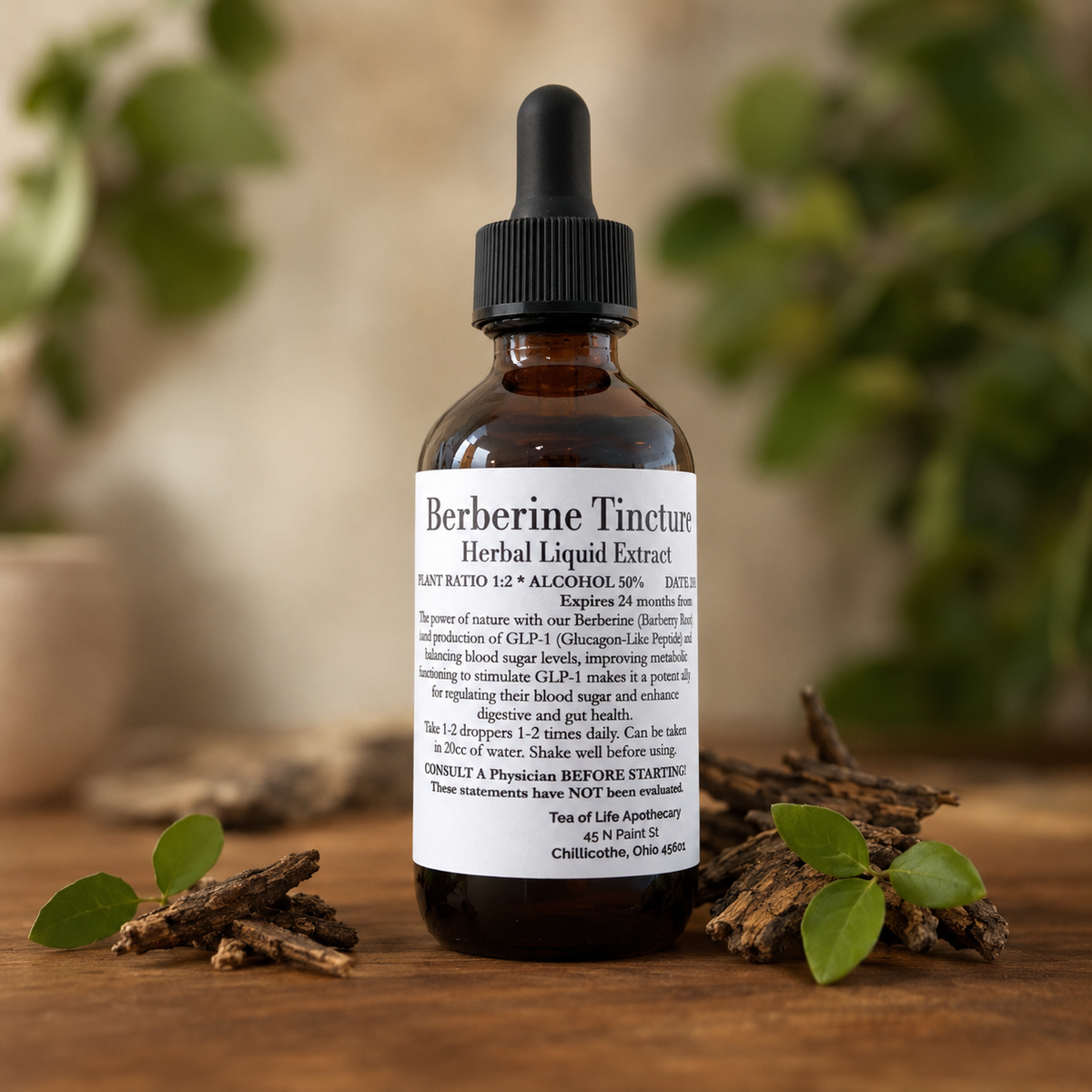 Tea of Life Apothecary Berberine Tincture in an amber glass dropper bottle displayed with natural barberry root and green leaves.