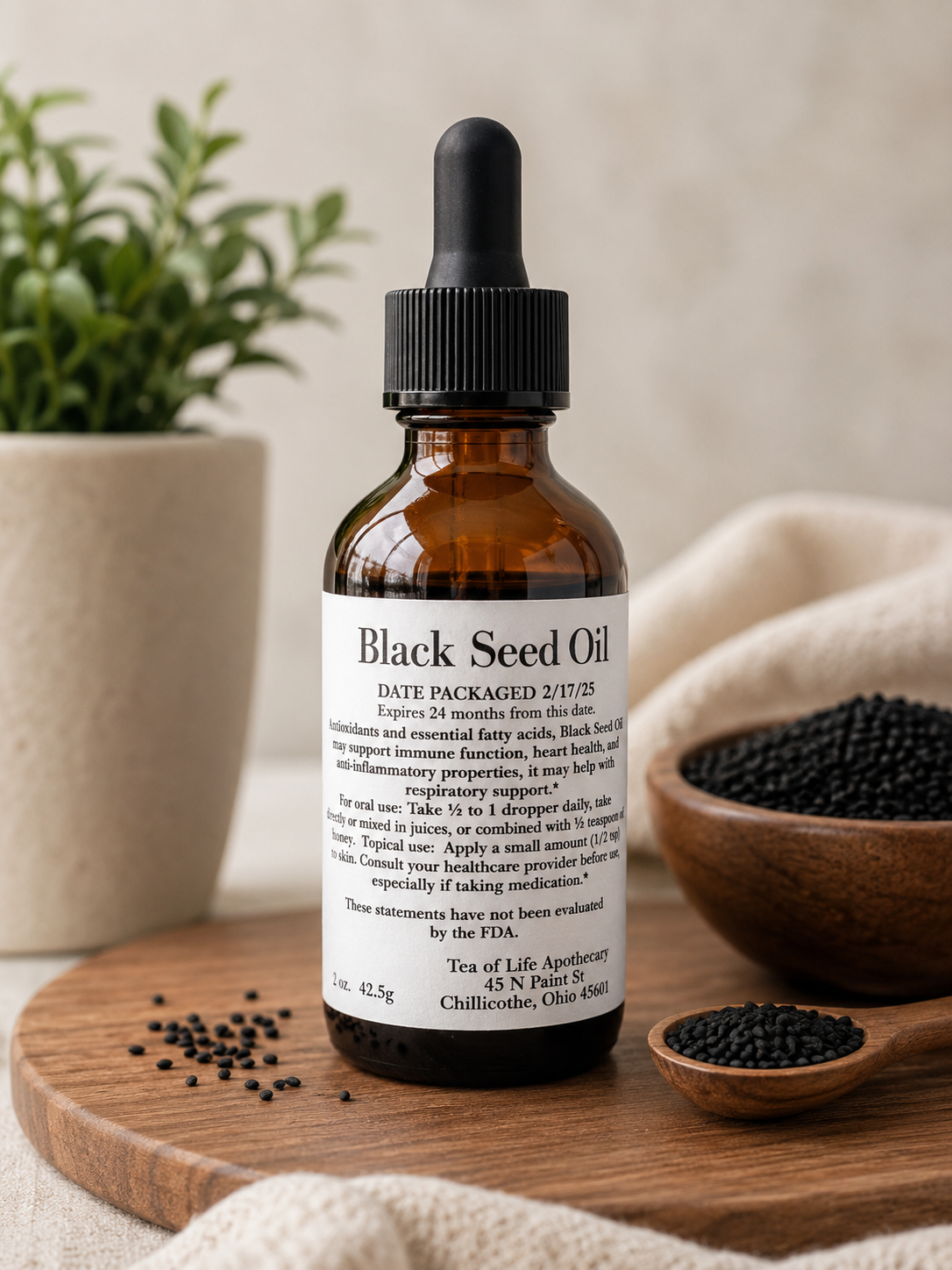 Amber glass Black Seed Oil tincture bottle displayed on a wooden tray with black seeds, soft natural lighting, and botanical wellness decor in a neutral apothecary setting.