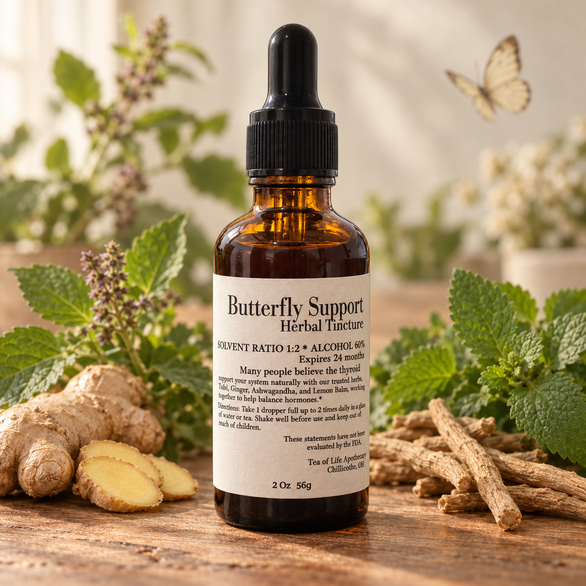 Butterfly Support Herbal Tincture by Tea of Life Apothecary in a 2-ounce amber dropper bottle, surrounded by ginger, tulsi, lemon balm, ashwagandha root, and a delicate butterfly.