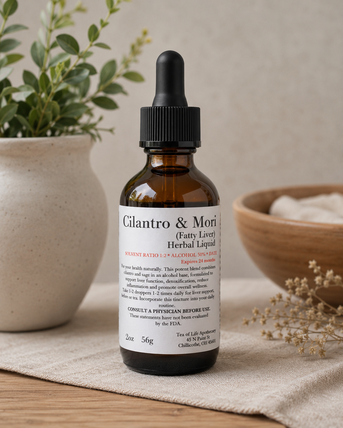 Amber glass Cilantro and Moringa herbal tincture bottle for fatty liver support displayed on a neutral fabric surface with soft natural lighting and botanical wellness decor.