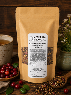 Cranberry Comfort Herbal Tea by Tea of Life Apothecary displayed with cranberries, soothing herbs, and a warm cup of tea in a rustic wellness-inspired setting for urinary tract support.