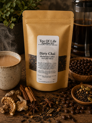 Tea of Life Apothecary Dirty Chai Mushroom Coffee Tea Blend displayed with freshly brewed coffee, whole coffee beans, cinnamon sticks, star anise, cardamom, medicinal mushrooms, and chai spices on a rustic wooden table, showcasing this bold, energizing tea and coffee fusion.