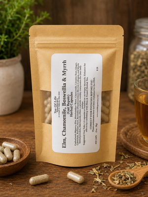 Tea of Life Apothecary Elm, Chamomile, Boswellia & Myrrh Gut Repair Herbal Capsules displayed in a rustic apothecary setting with herbal capsules, loose herbs, and tea on a wooden table.