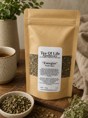 Energize Yerba Mate herbal tea by Tea of Life Apothecary displayed in a warm rustic setting with loose leaf herbs, ceramic tea cup, and natural earthy decor to highlight natural energy and mental focus support.