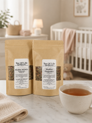 Tea of Life Apothecary Healthy Pregnancy and Healthy MAMA herbal tea blends displayed on a countertop beside a warm cup of tea, with a softly blurred baby nursery featuring a crib and nursery décor in the background.
