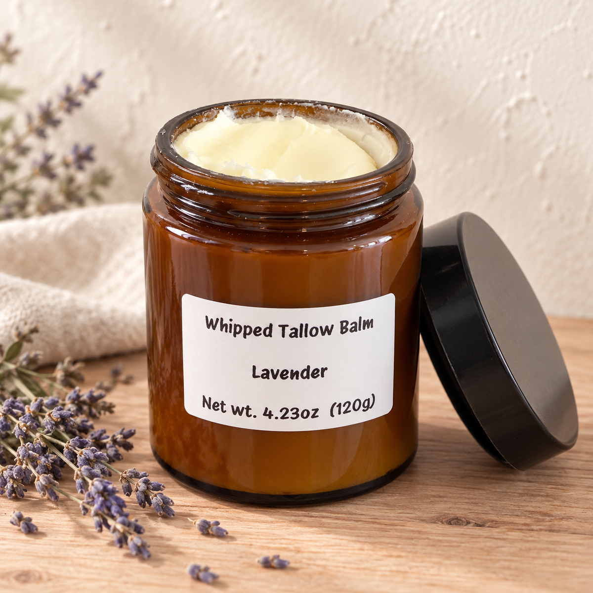 Amber jar of Lavender Whipped Tallow Balm with creamy balm and dried lavender, handcrafted for moisturizing and nourishing dry skin.