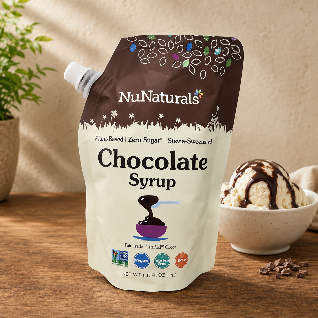 NuNaturals sugar-free chocolate syrup pouch beside vanilla ice cream drizzled with rich chocolate syrup.