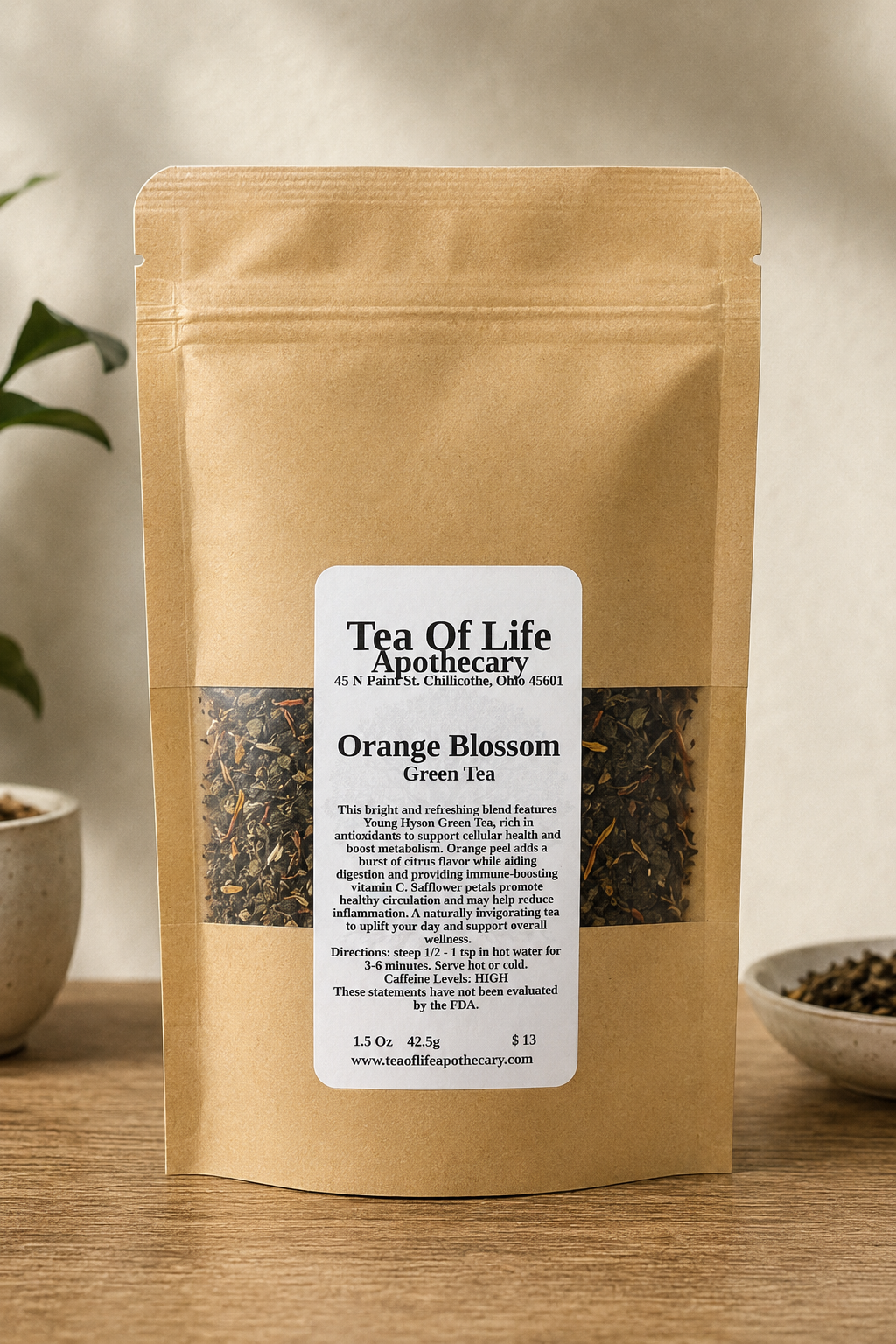 Orange Blossom Green Tea loose leaf tea by Tea of Life Apothecary in a kraft stand-up pouch, featuring antioxidant-rich green tea with orange peel and safflower petals, displayed in a natural apothecary-style product setting.