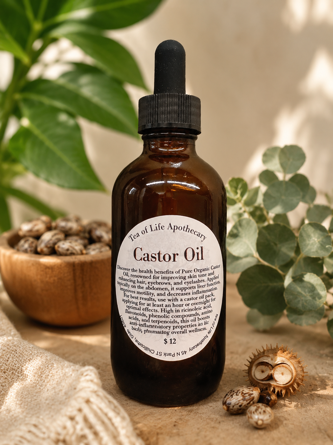 Organic hexane-free castor oil in an amber glass dropper bottle surrounded by castor seeds and natural botanicals, showcasing a premium cold-pressed castor oil for hair, skin, eyelashes, eyebrows, nails, and castor oil pack wellness applications.