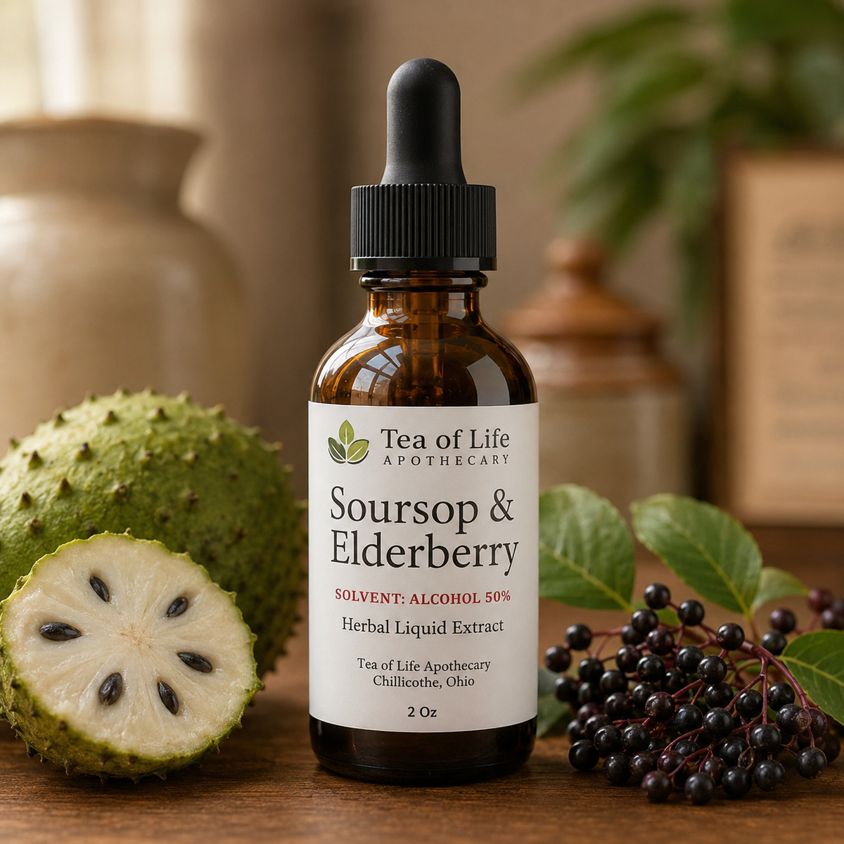 Tea of Life Apothecary Soursop and Elderberry herbal tincture in an amber dropper bottle displayed with fresh soursop fruit and elderberries.