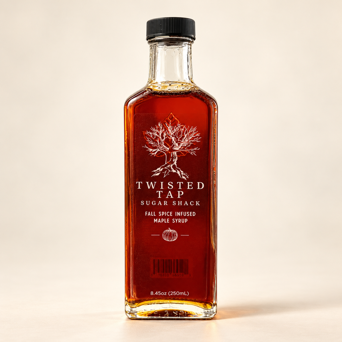 Twisted Tap Fall Spice Infused Maple Syrup in a tall 250 mL glass bottle on an ivory background.
