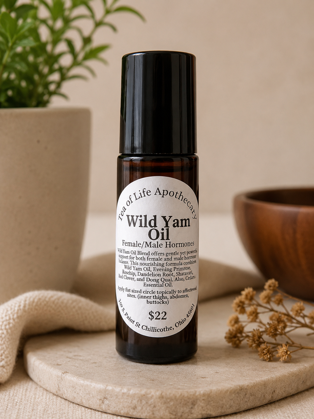 Wild Yam Oil hormone balance roll-on bottle from Tea of Life Apothecary displayed in a soft natural wellness setting with neutral decor, botanical accents, and calming spa-inspired lighting.